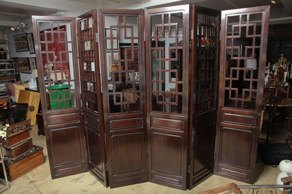 A six-panel folding screen in a dark wood finish, with traditional Chinese lattice pannels. Expands to 126