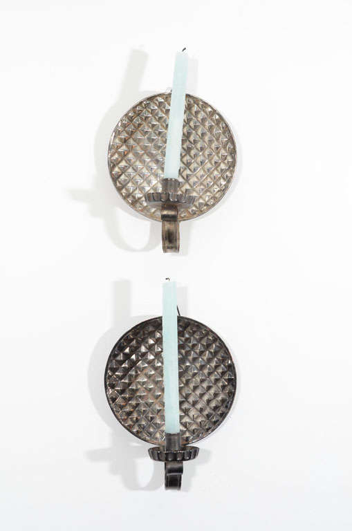 Pair of circular wall mounted candleholders