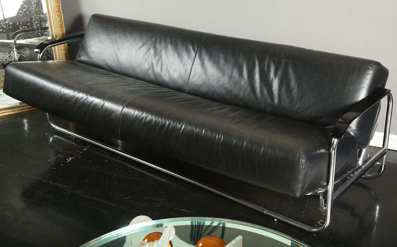 Chrome-plated steel frame, ebonized wood, leather upholstery 
Model no. 63