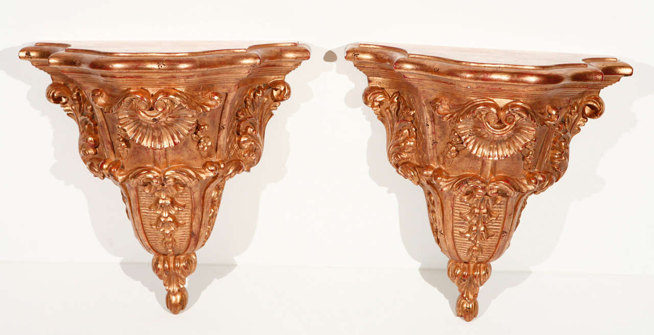 Pair of large, Italian, carved and gilded wall brackets with shell motifs.