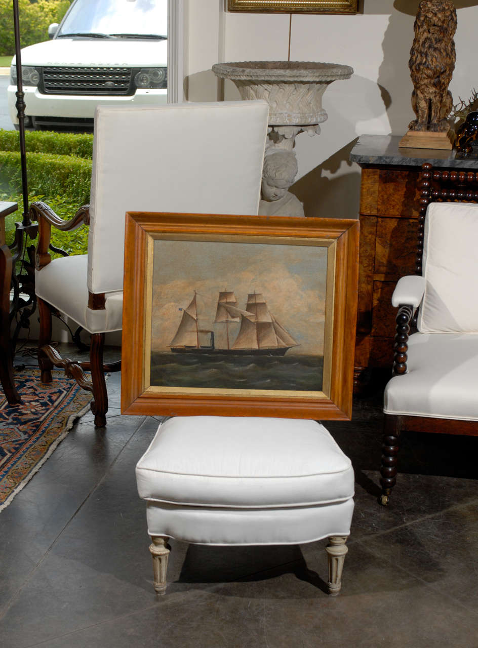 Oil on board of a ship with an American flag blowing in the wind. Antique Wooden frame.