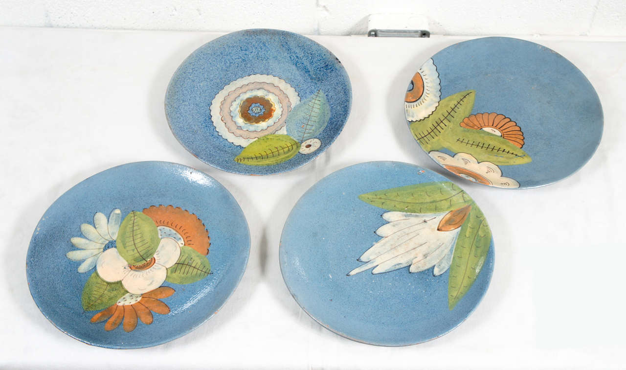Here is a beautiful set of four ceramic plates with painted  water lilies.