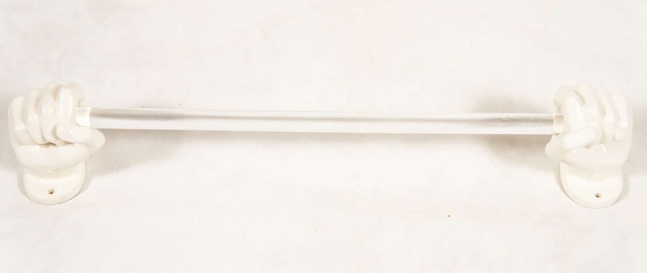 Here is a unique hand towel holder. The hands are porcelain and the bar is made of lucite.