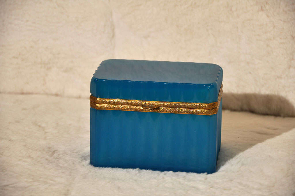 Seeing as these opaline boxes are next to impossible to find, I am thrilled to offer this gorgeous vintage deep blue rippled opaline casket box. Still has the original sticker. great condition and a stunning color.