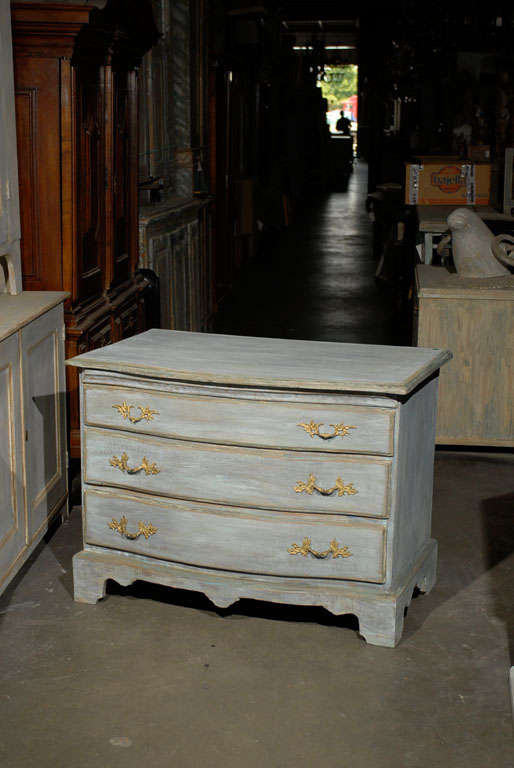 A Swedish 18th century period Rococo three-drawer painted wood chest with scalloped skirt and bracket feet.