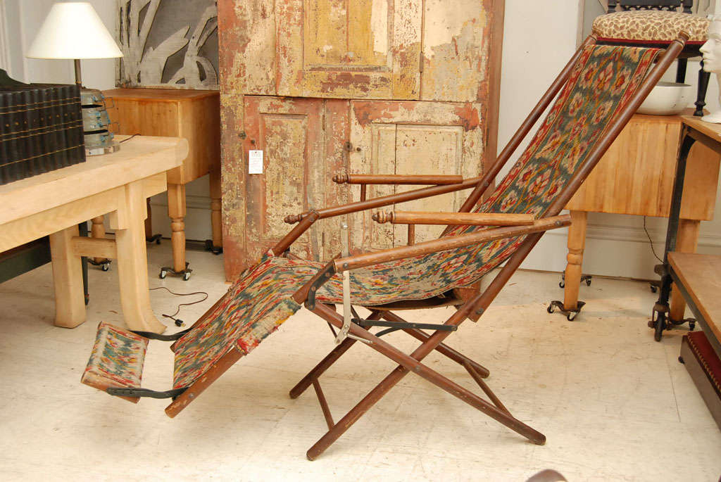 Unique Oriental carpet adjustable recliner with original hardware and footrest.<br />
Folds easily for storage