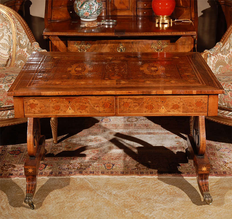 Stunning, intricately inlaid table with rosewood marquetry, unique lyre legs and claw feet.