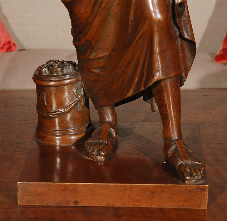 Hand-cast bronze statue of a Roman senator next to a basket of scrolls from the Giovanni Nisini foundry in Rome, Italy. Inscribed 
