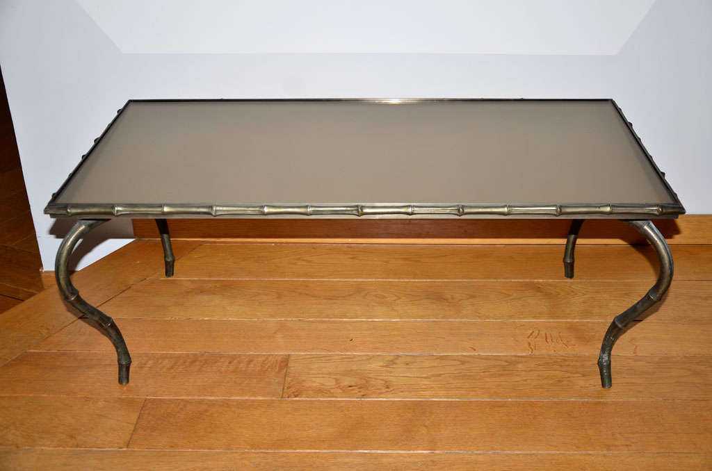 Impressive silvered bronze "Bambou" (bamboo) coffee table executed by Maison Baguès, Paris (F). Frame and feet in bamboo decor with a mirror top.