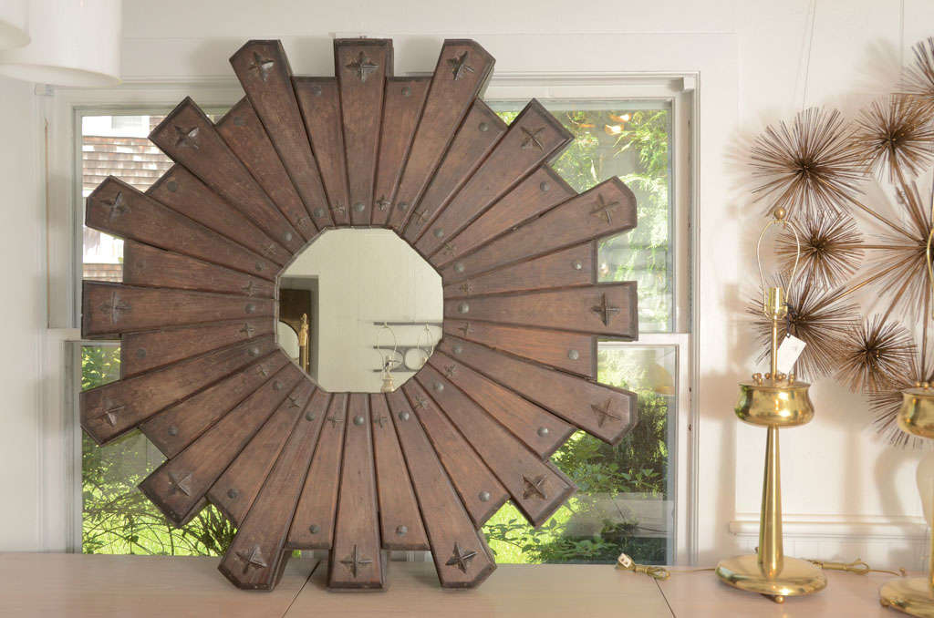 Starburst Mirror Wall Sculpture made of dark wood and iron nail accents.