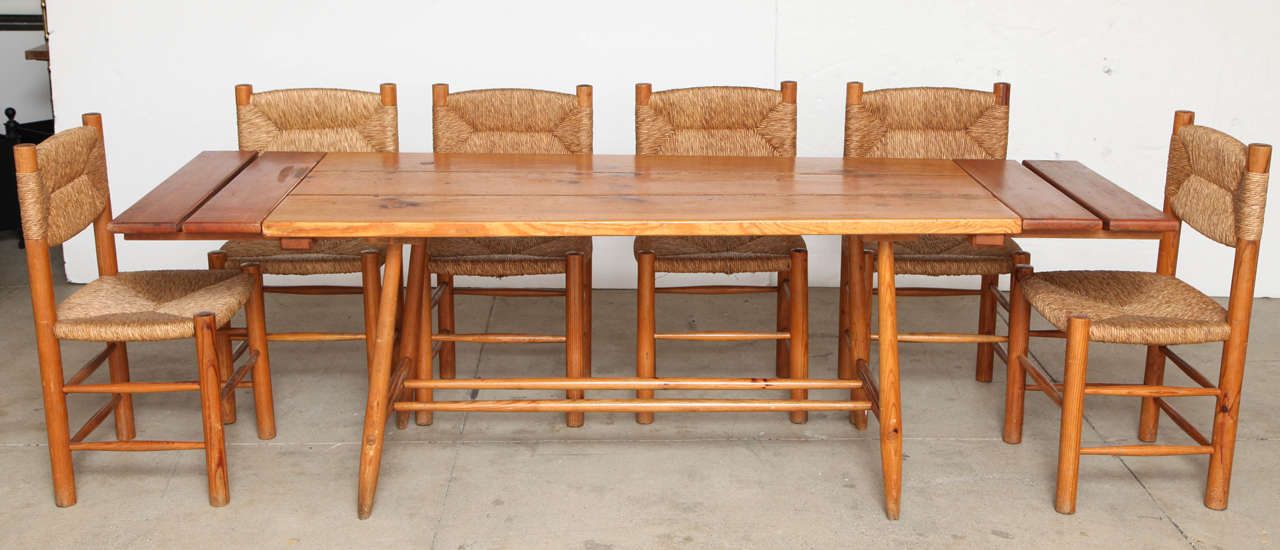 Charlotte Perriand pine table and six chairs with original straw.