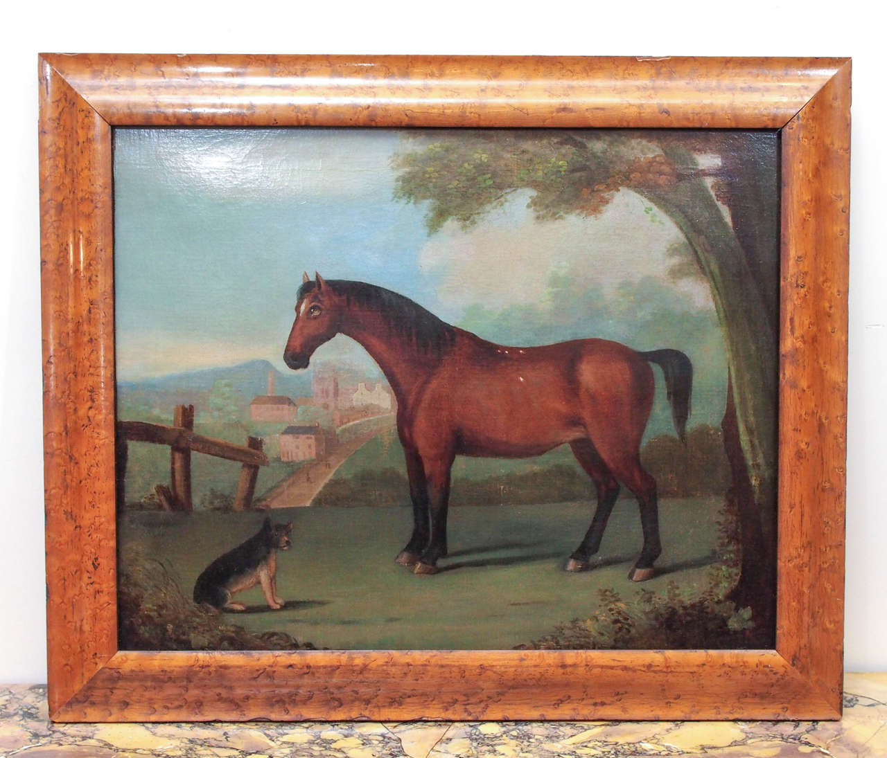 Portrait of a horse in naive setting with a dog on a hill above a town. In Birdseye maple frame. Inverso 