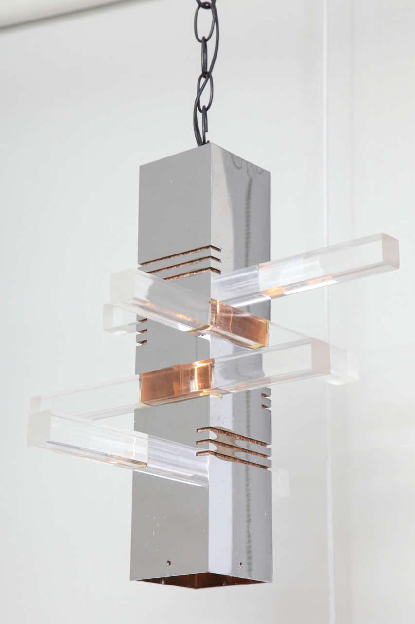 A chrome pendant light fixture with Lucite extending spires. USA, circa 1970.  Newly rewired for U.S.  Measures 14.25 inches tall; includes 24 inches of hanging chain.