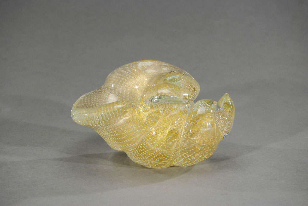 This hand blown crystal shell is a large example and very heavy. The internal layer is filled with gold leaf and the outer cased layer is extremely well executed controlled bubbles, in a technique named 