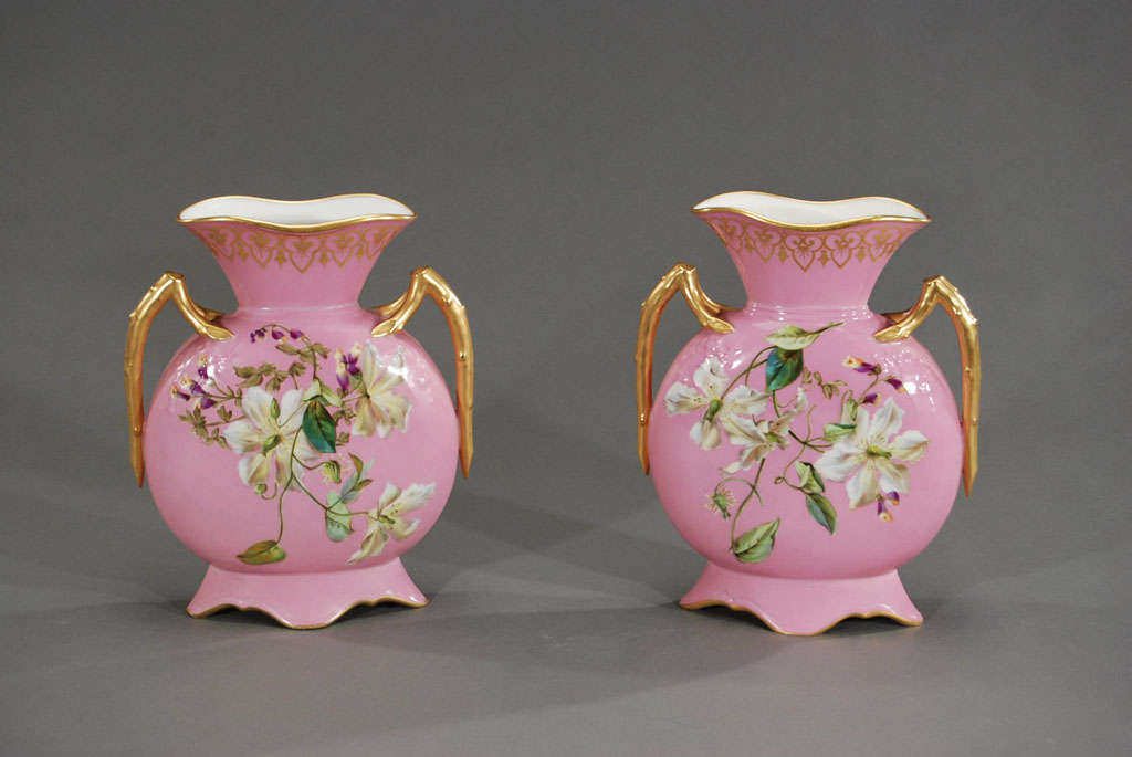This lovely matched pair of hard paste porcelain mantel vases features hand-painted clematis flowers on a 