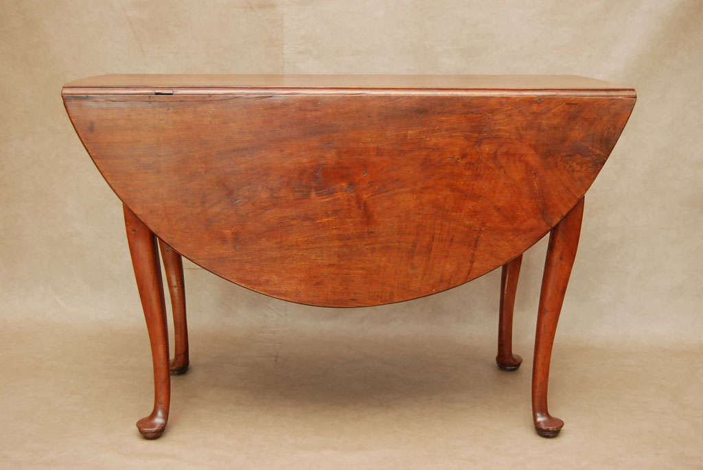 A handsome pre-Revolutionary War New England drop leaf dining table. Notice the highly figured walnut on the top. New England walnut dwindled in availability by the mid 18th century as most had been cut down for furniture  making and fine home