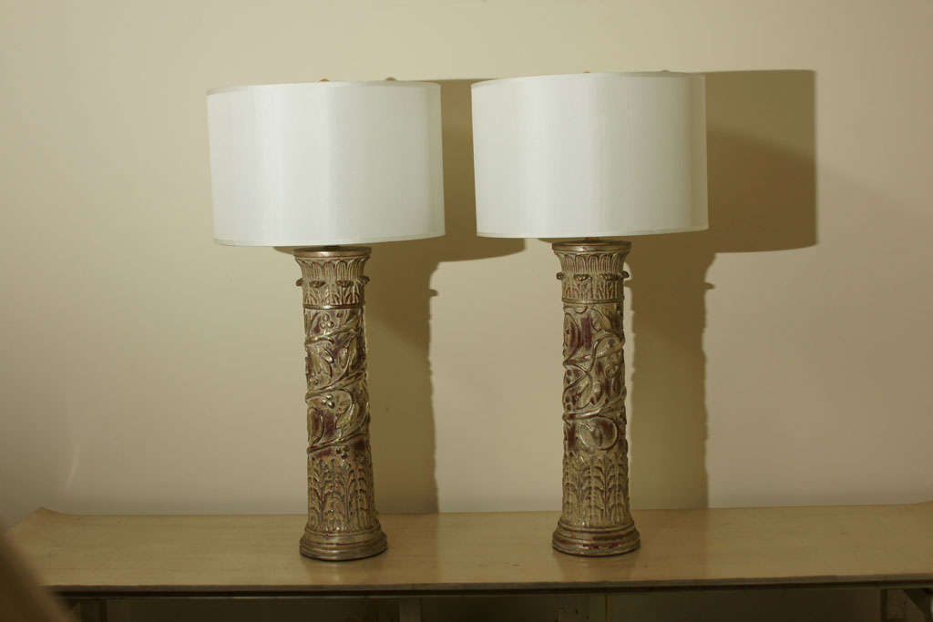 Pair of large column lamps by JAMES MONT. the lamp bodies are made of carved wood in the form of classical columns decorated with spiraling tendrils and leaves. The lamps still retain their original leafed finish, which has had minimal repairs and