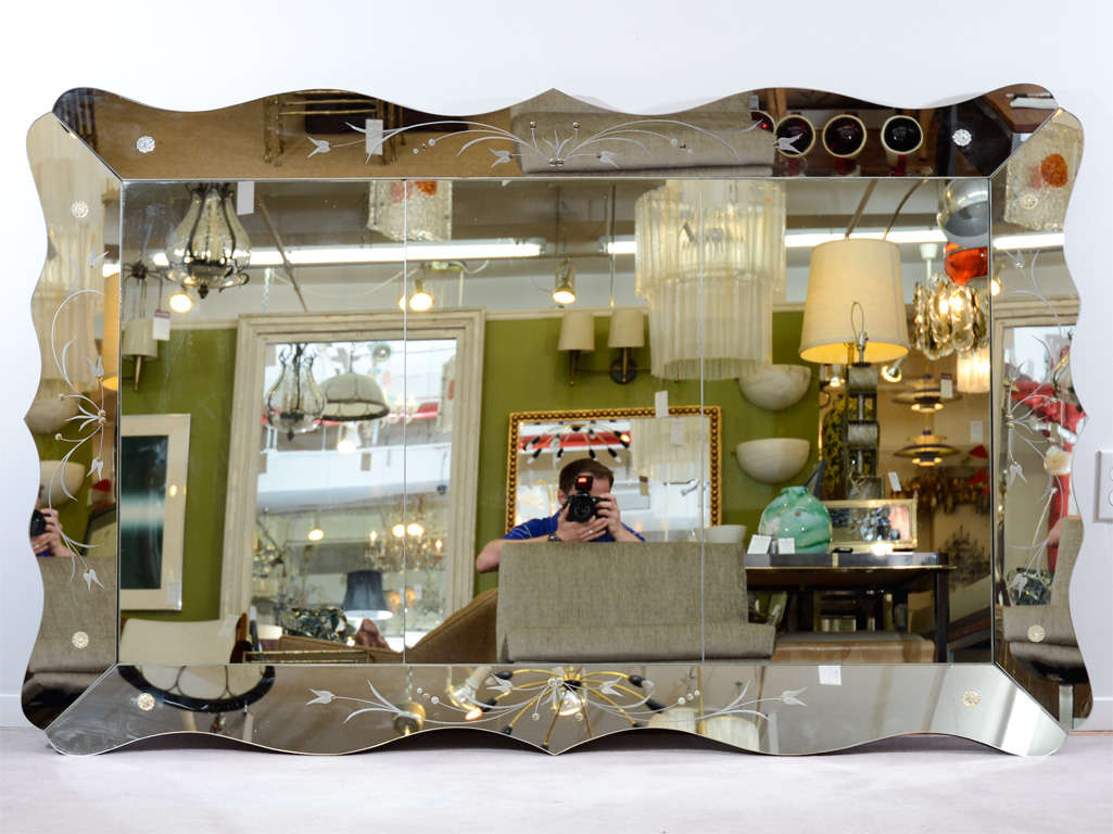 A Hollywood Regency mirror with floral motif etching in a scalloped border.<br />
<br />
Reduced From: $1450