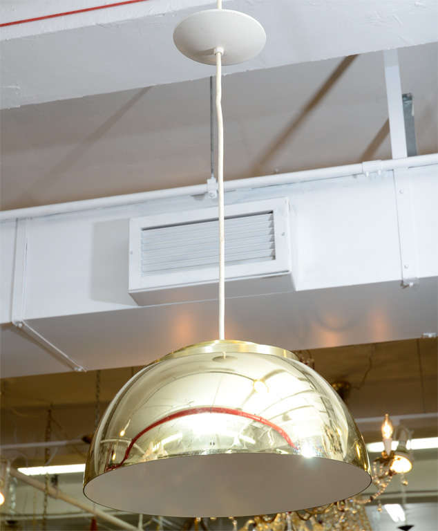 A mid century brass half-globe form light fixture by Lightolier. The piece has an enameled white interior and takes a single bulb.<br />
<br />
Reduced From: $1500
