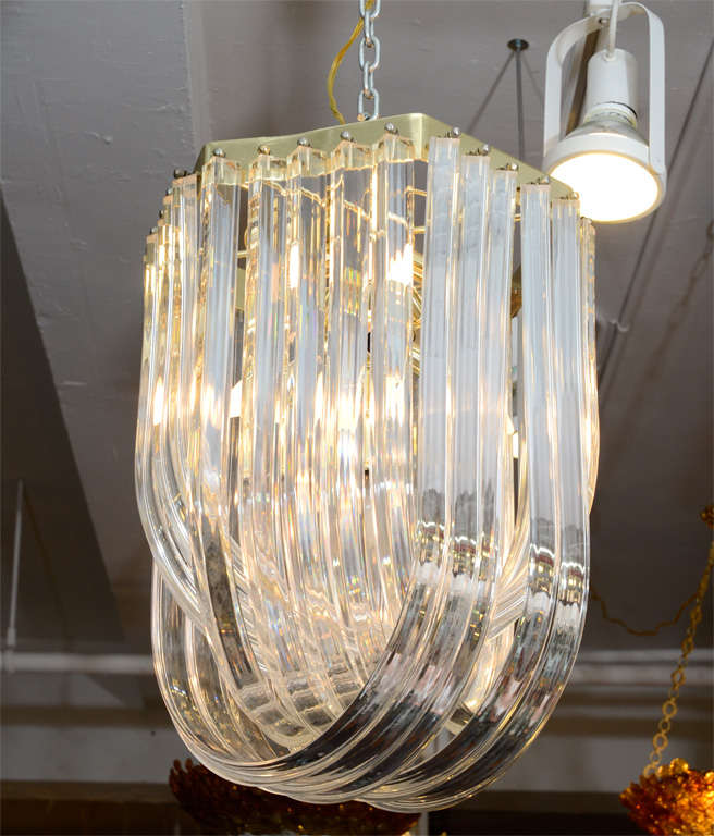 Mid century chandelier comprised of arching lucite rods that weave inwards. Each lucite rod is mounted to a brass base.<br />
<br />
Reduced From: $3800