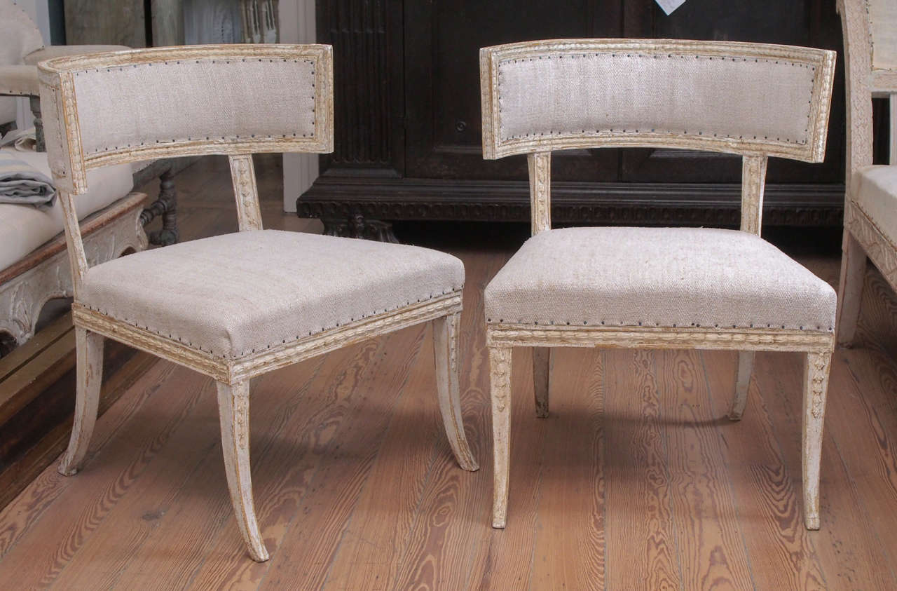 Swedish Klismos chairs signed ES (Ephriam Stahl.  Carved legs, back, stiles and rail.  Sabre legs.  Upholstered in linen.