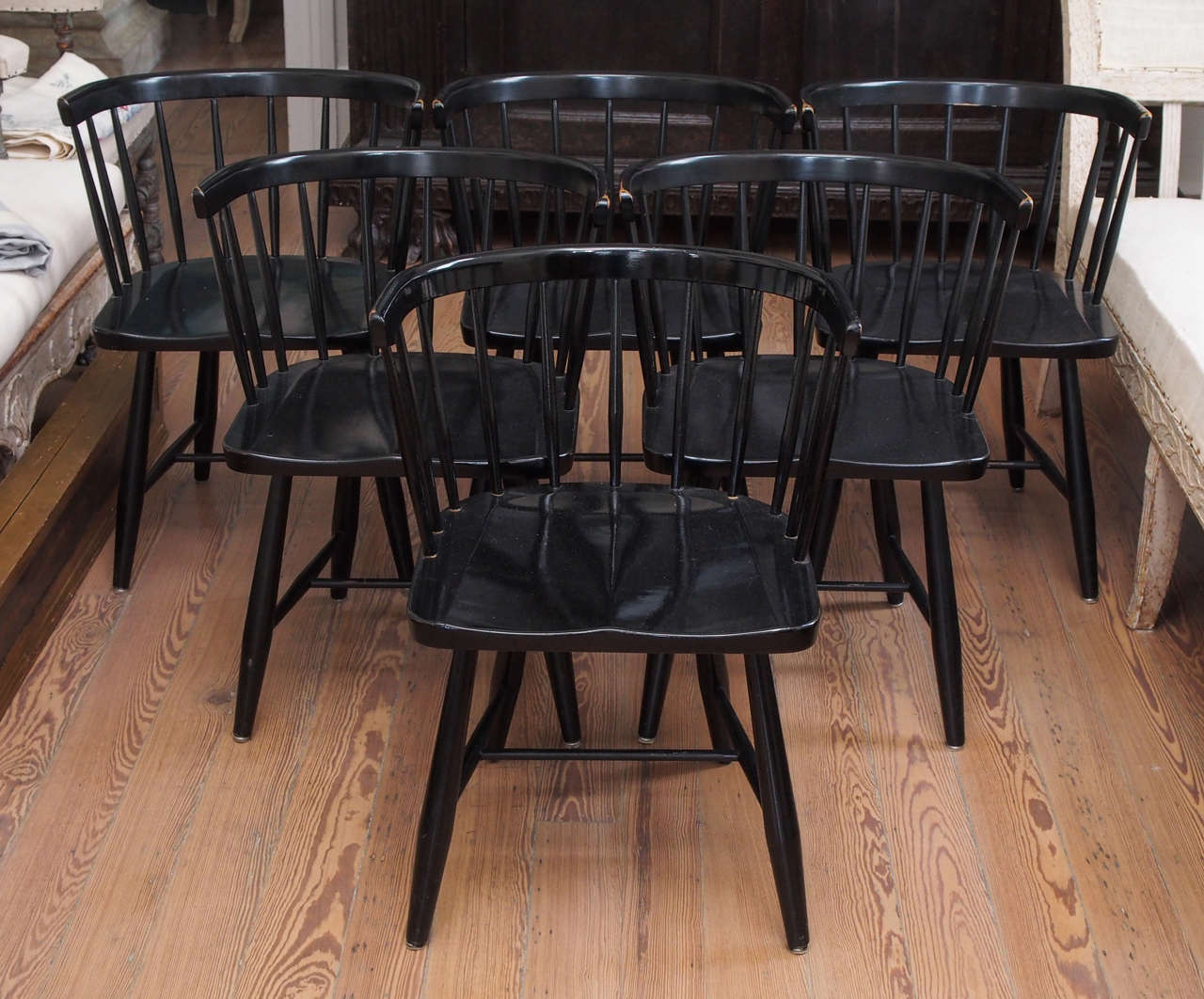 Attractive set of 12 black-lacquered barrel-back dining chairs.