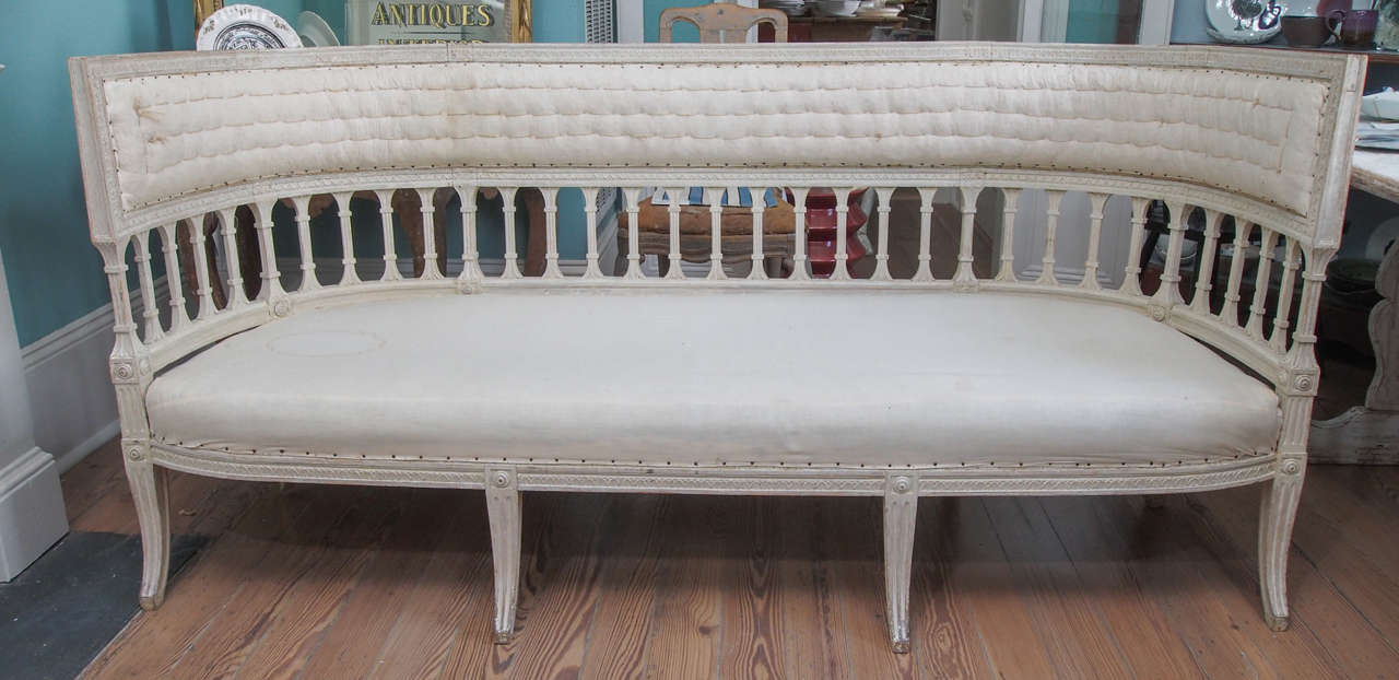 Early and very refined Gustavian sofa with a curved, Klismos inspired back, sabre legs, and carving of extremely high quality.  Possibly by the maker Ephriam Stahl.