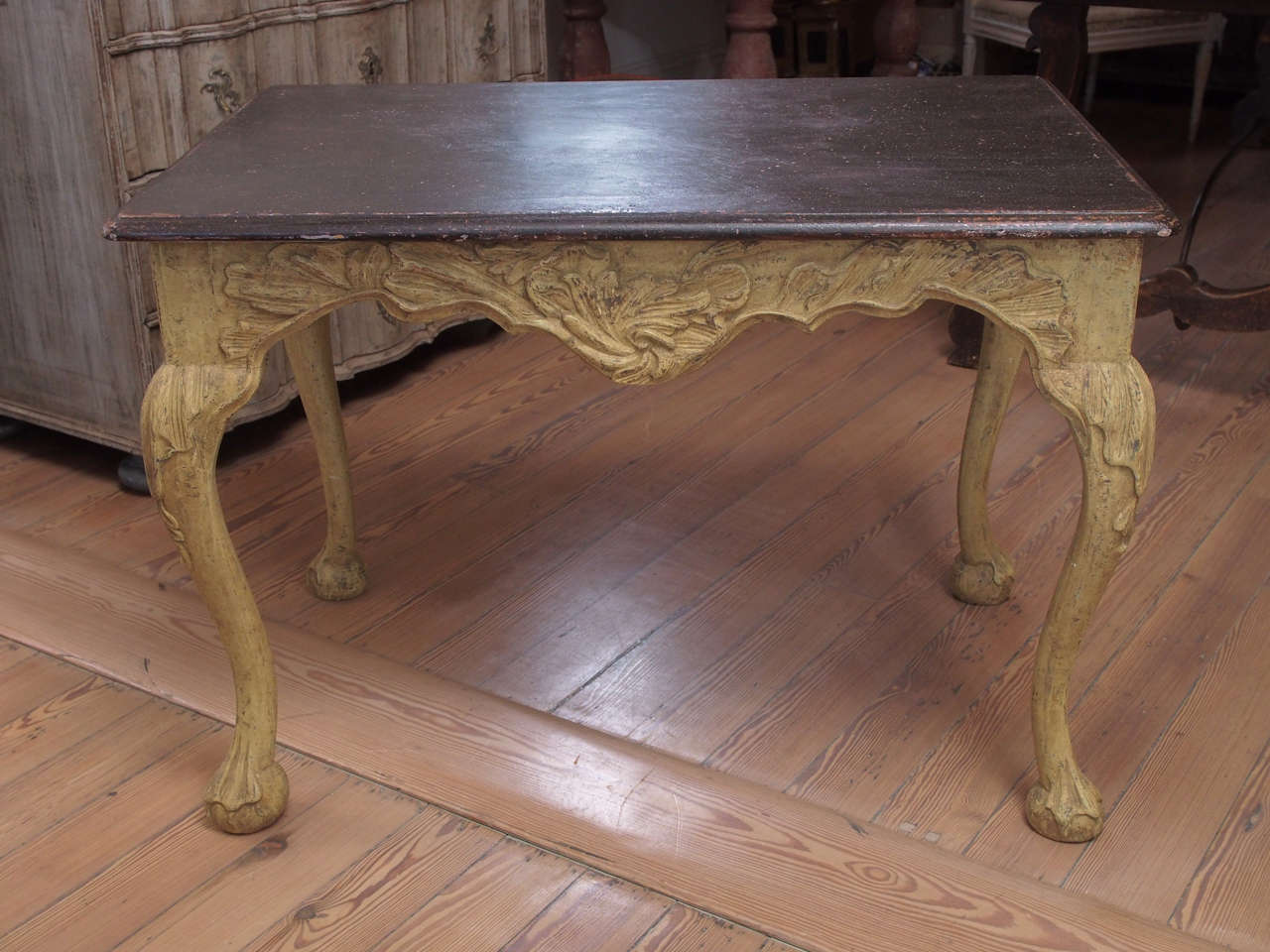 Center table with faux porphory top and carved cabriole legs and apron.
