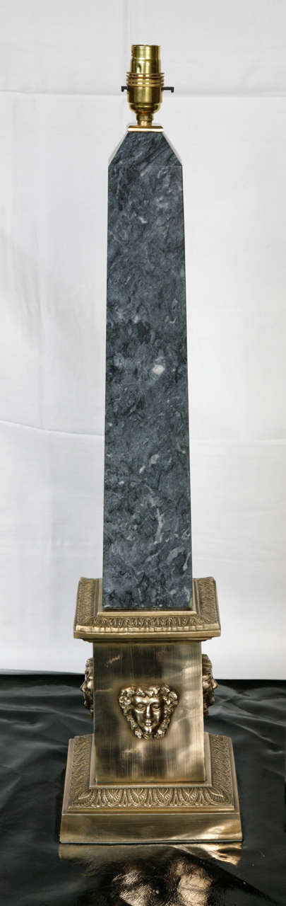 Slate Marble Obelisk Column Lamps circa 1960. Set of 2. Beautifully decorated with gold embossed figure heads.

Please contact us for shipping costs.