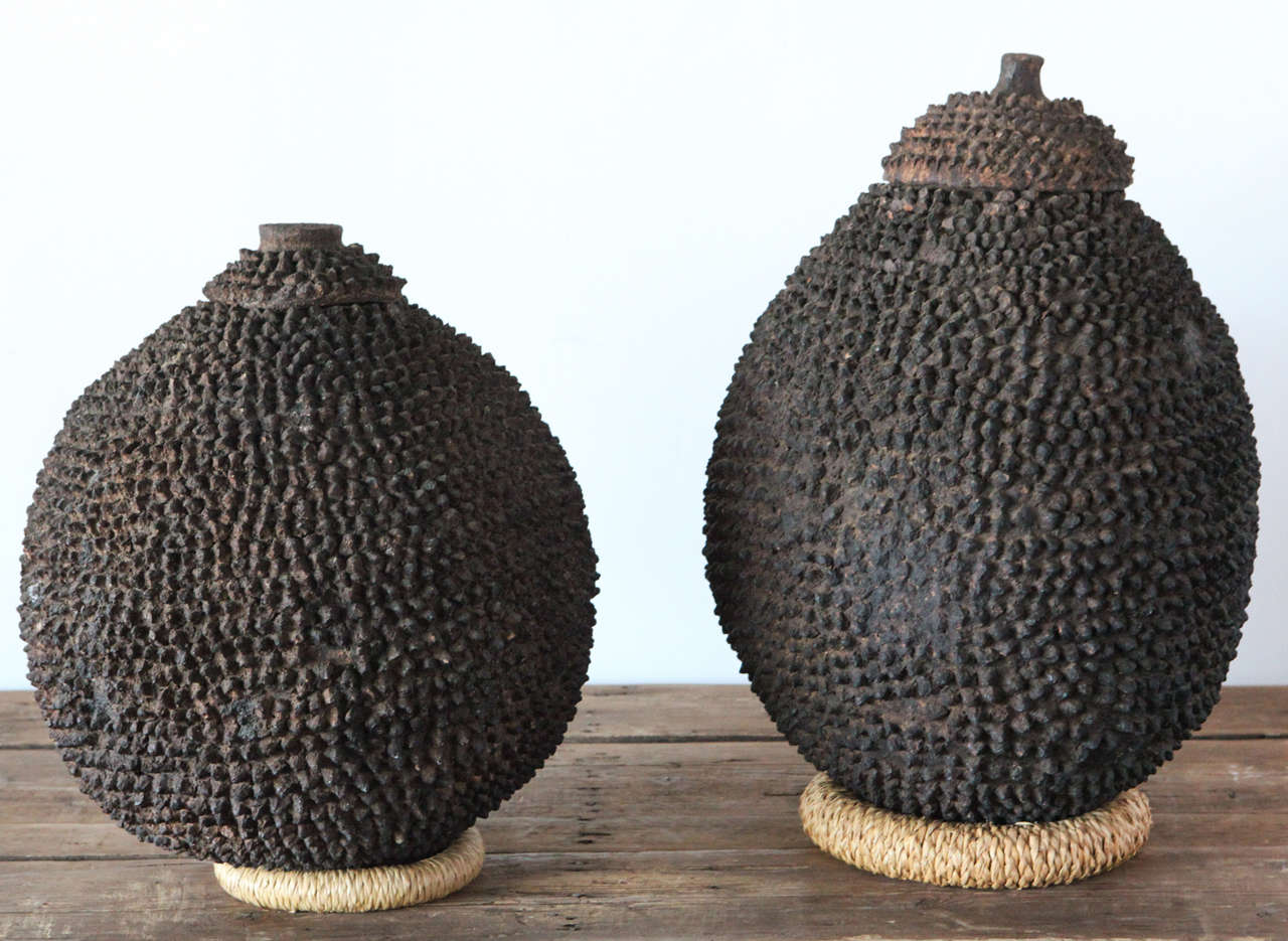 a pair of lobi pots in their traditional burnt spiked clay formations. 
*sold individually.
measurements are as follows:
left :   ht 20