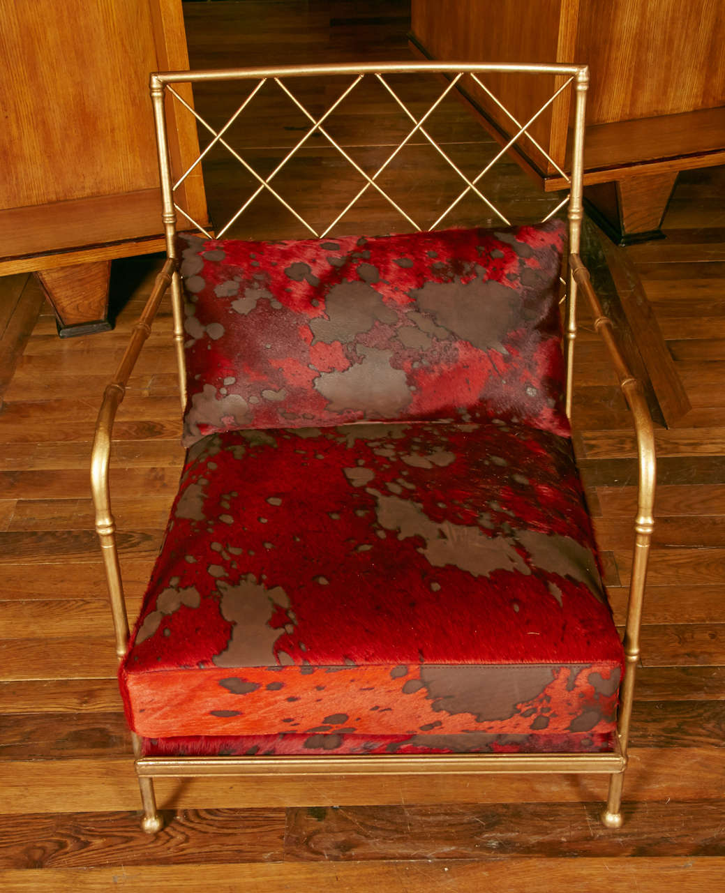 Pair of bamboo style gilt metal armchairs, back and set covered with red cowhide from Rubelli.
