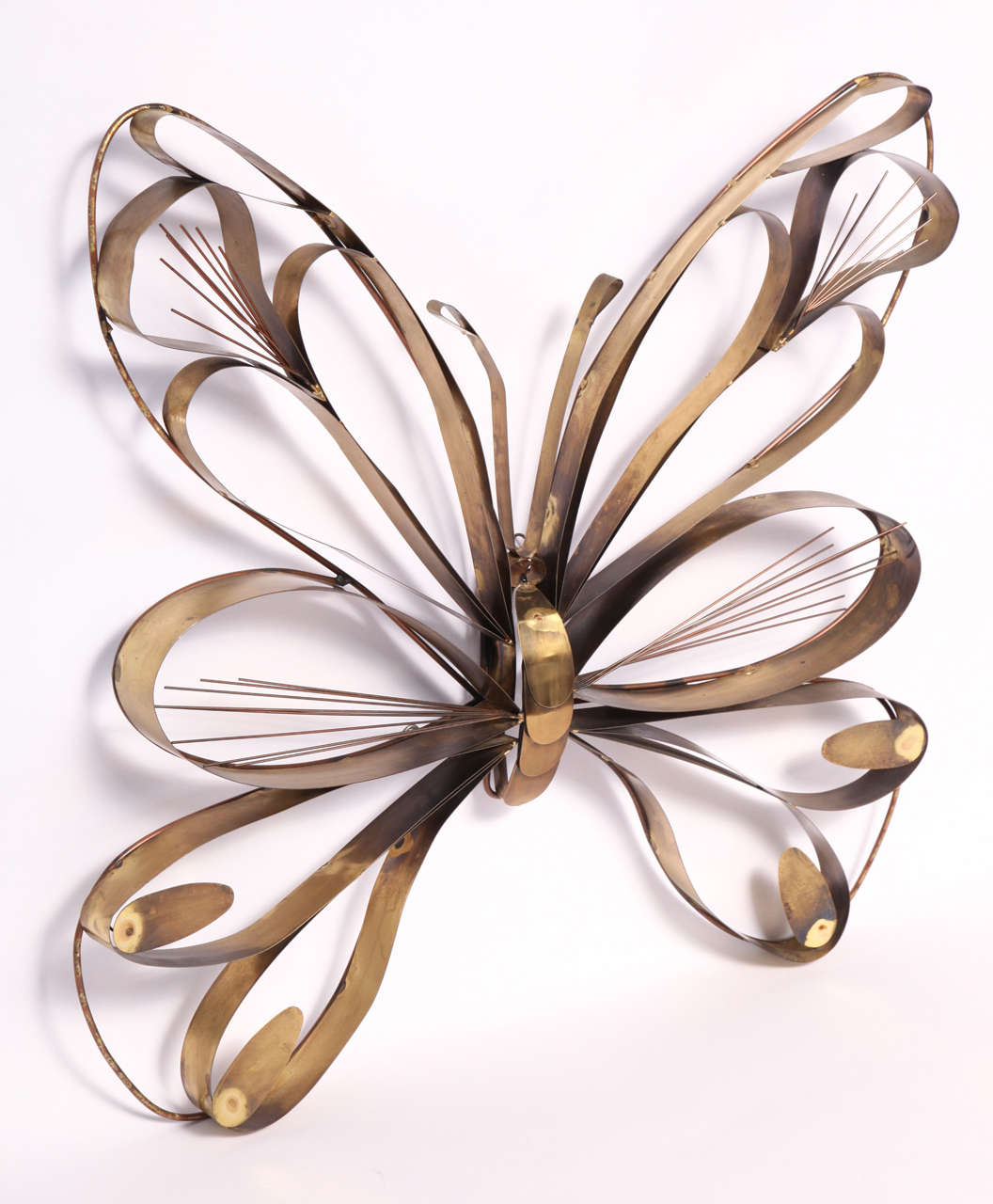 Large symmetric brass butterfly wall sculpture beautifully constructed by Curtis Jeré. Made in 1978, this sculpture is a brilliant example of Curtis Freiler and Jerry Fels' (Curtis Jeré) 