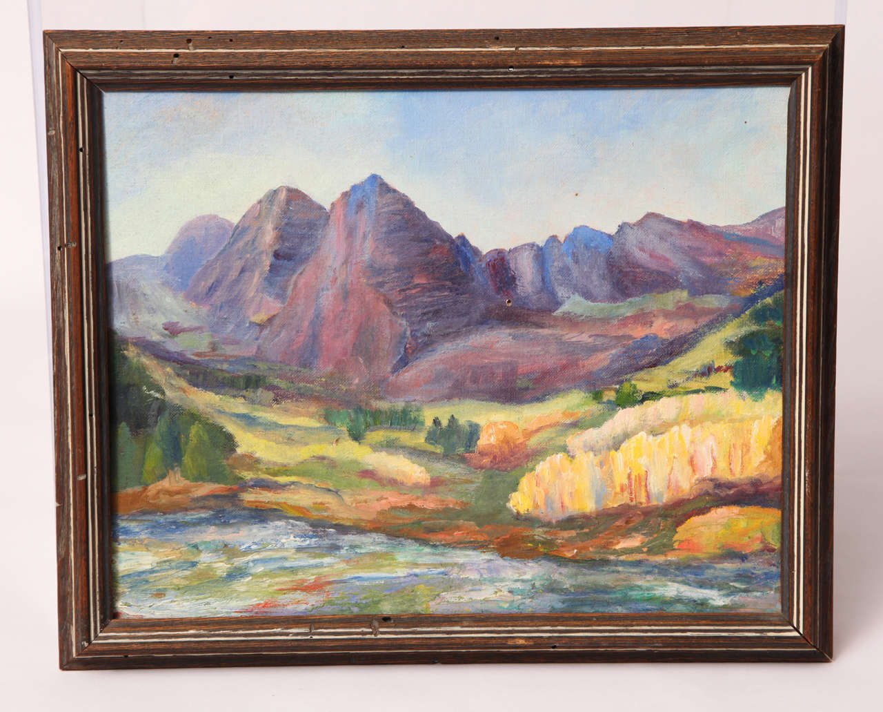 In true impressionist style, the lushness of the foreground is presented with short, thick brush strokes; contrasting the stark and jagged mountain range behind.