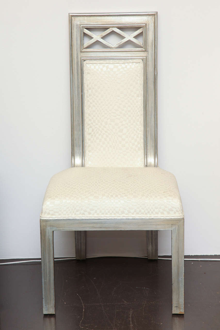 Upholstered side chair in wood with silver leaf finish with pierced criss-cross decoration on back.  
American, c. 1950s