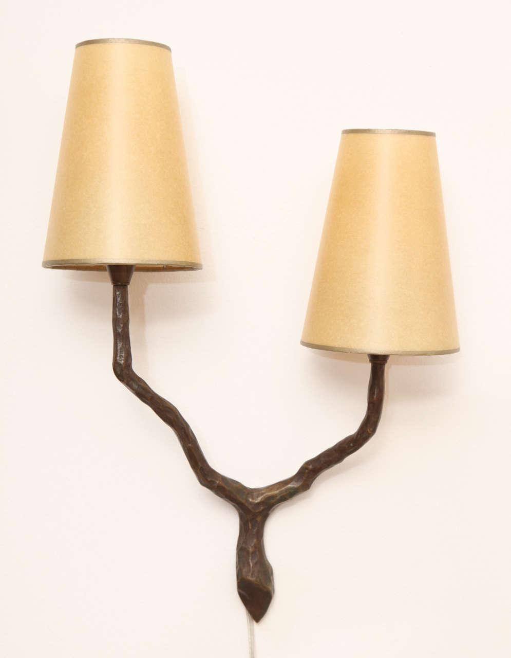 Felix Agostini (1910-1980).
Pair of two arm sconces in patinated bronze with parchment shades. 
French, circa 1960.