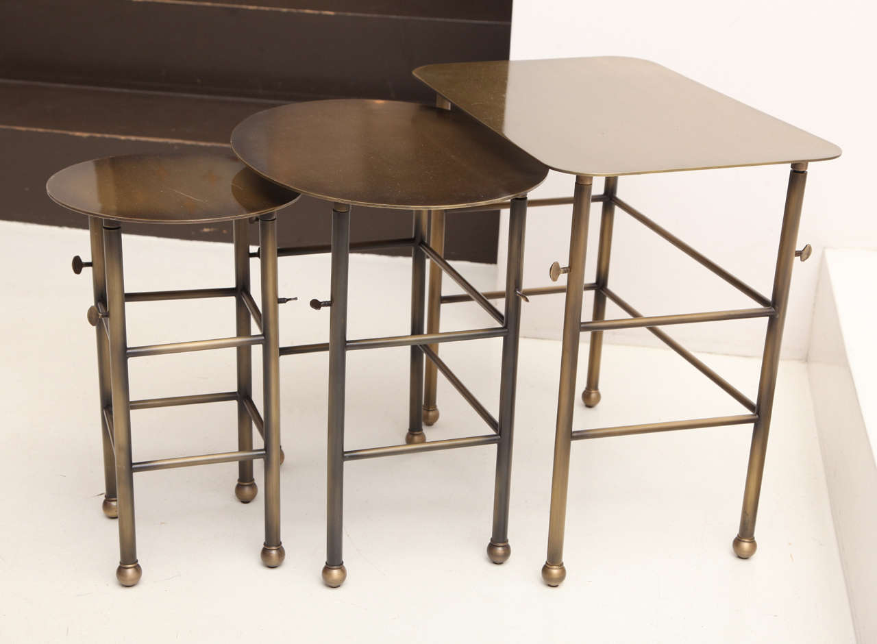 Elizabeth Nesting Tables
Set of 3 adjustable cocktail tables. Available in custom metal fabrication and plating. 
Shown in antique brass. 
Executed by West Knoll 

Square: 11.75”W x 18”D x 17.5”H/ Max extended 26” 
Oval: 11.75”W x 16”D x 16”H/