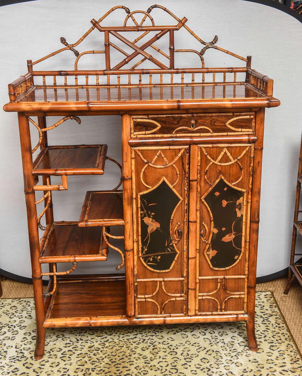 Superb English bamboo bookcase or cabinet with lacquer scene on doors and side. Beautiful bamboo roots on top.
Estate great piece!