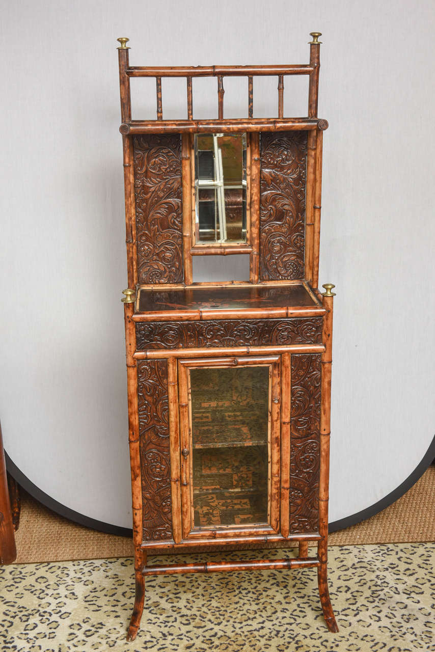 English bamboo cabinet lacquer top with glass window and leather paper all over .