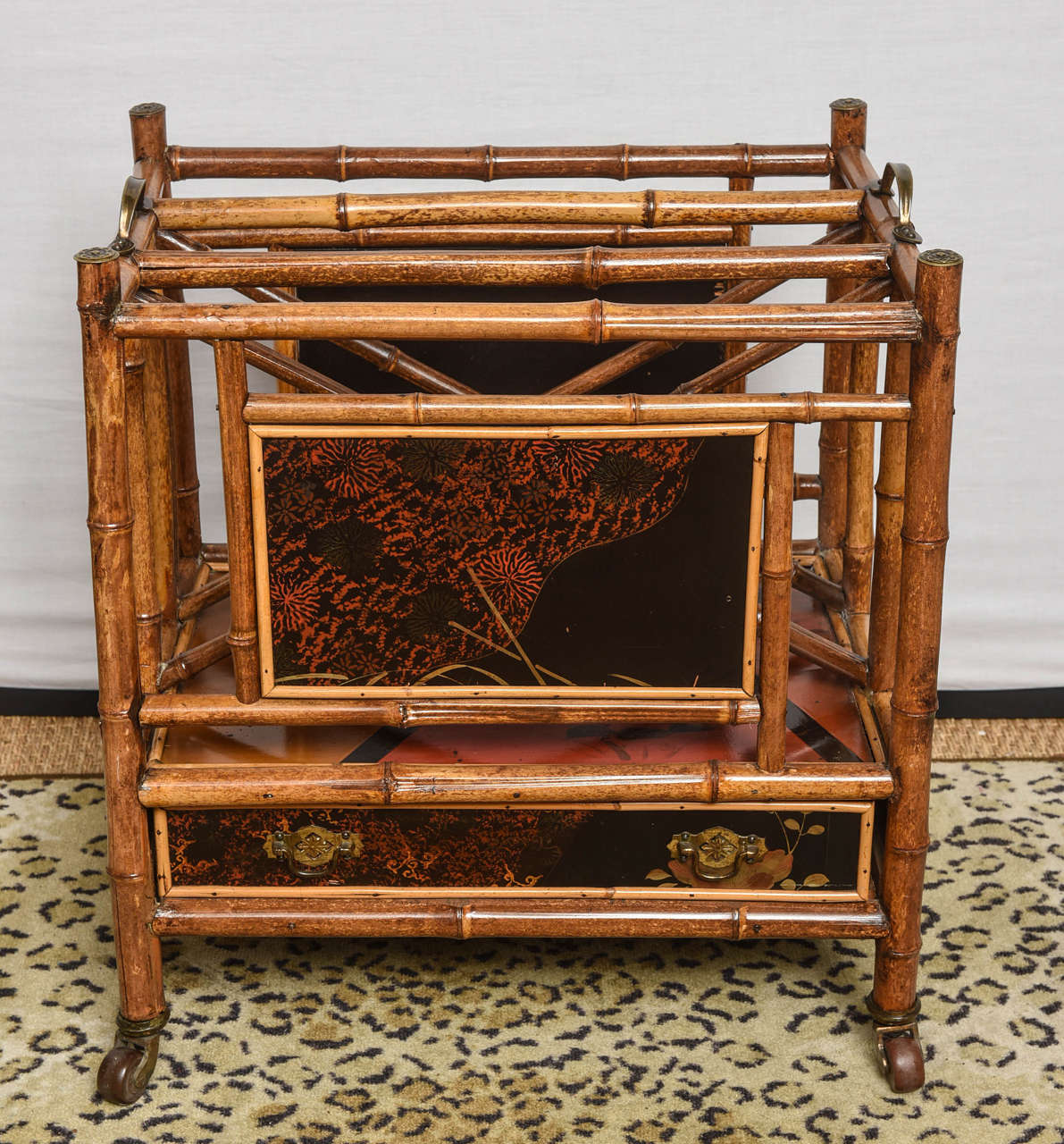 Rare 19th century English lacquer bamboo canterbury with handles and drawer on wheels.