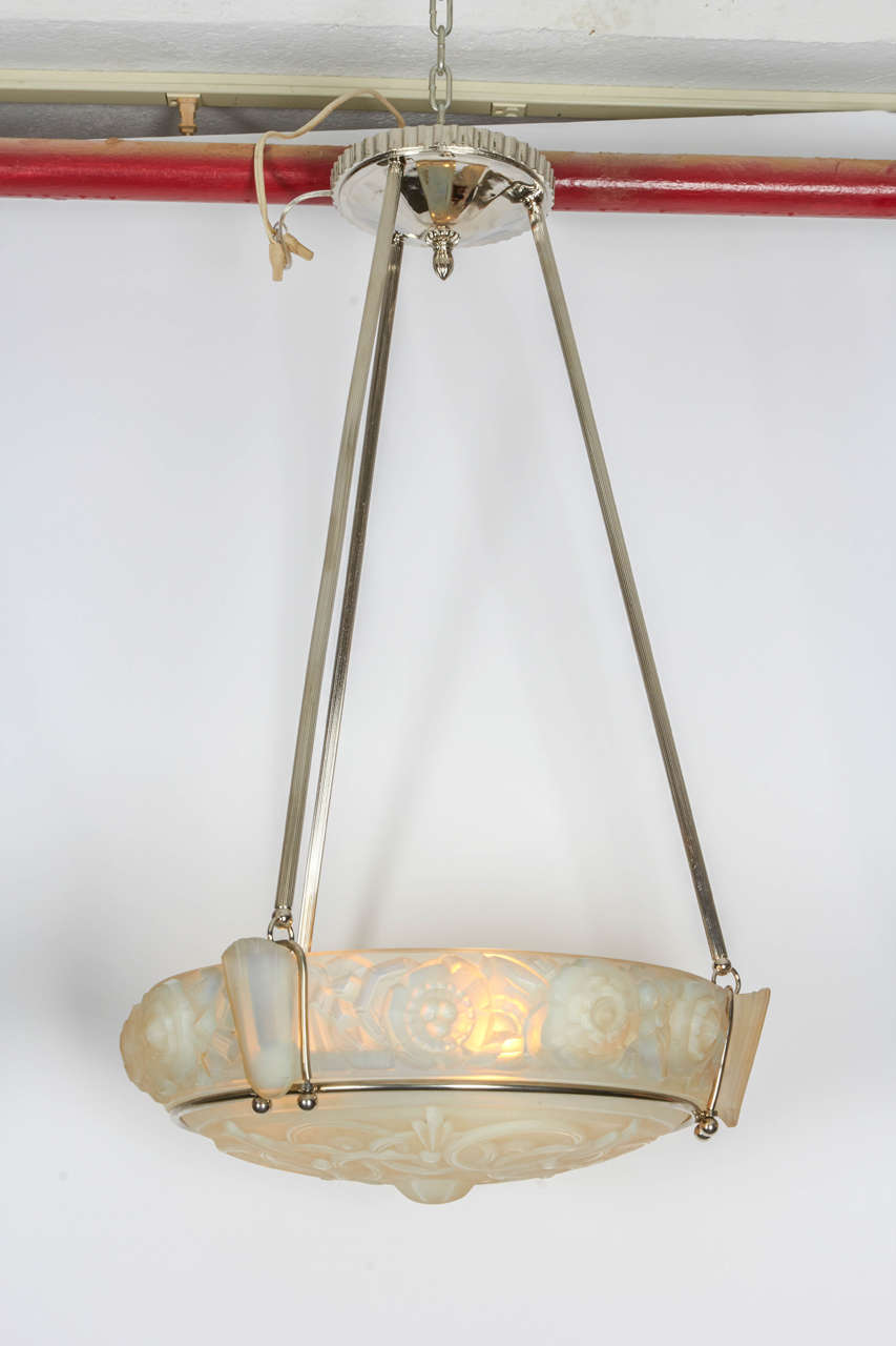 French Art Deco chandelier by Sabino, in opalescent glass supported by a nickel-plated canopy and rods.