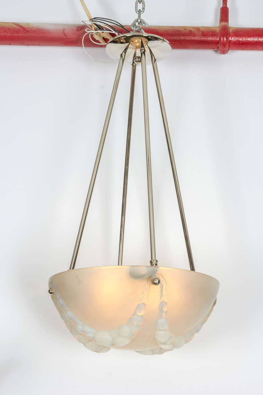 Signed Rene Lalique opalescent glass chandelier.
A design created on December 14, 1927.
New hardware.