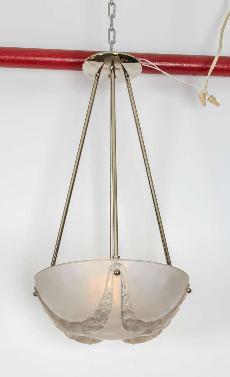 Clear and frosted glass chandelier by René Lalique.
The 12.25