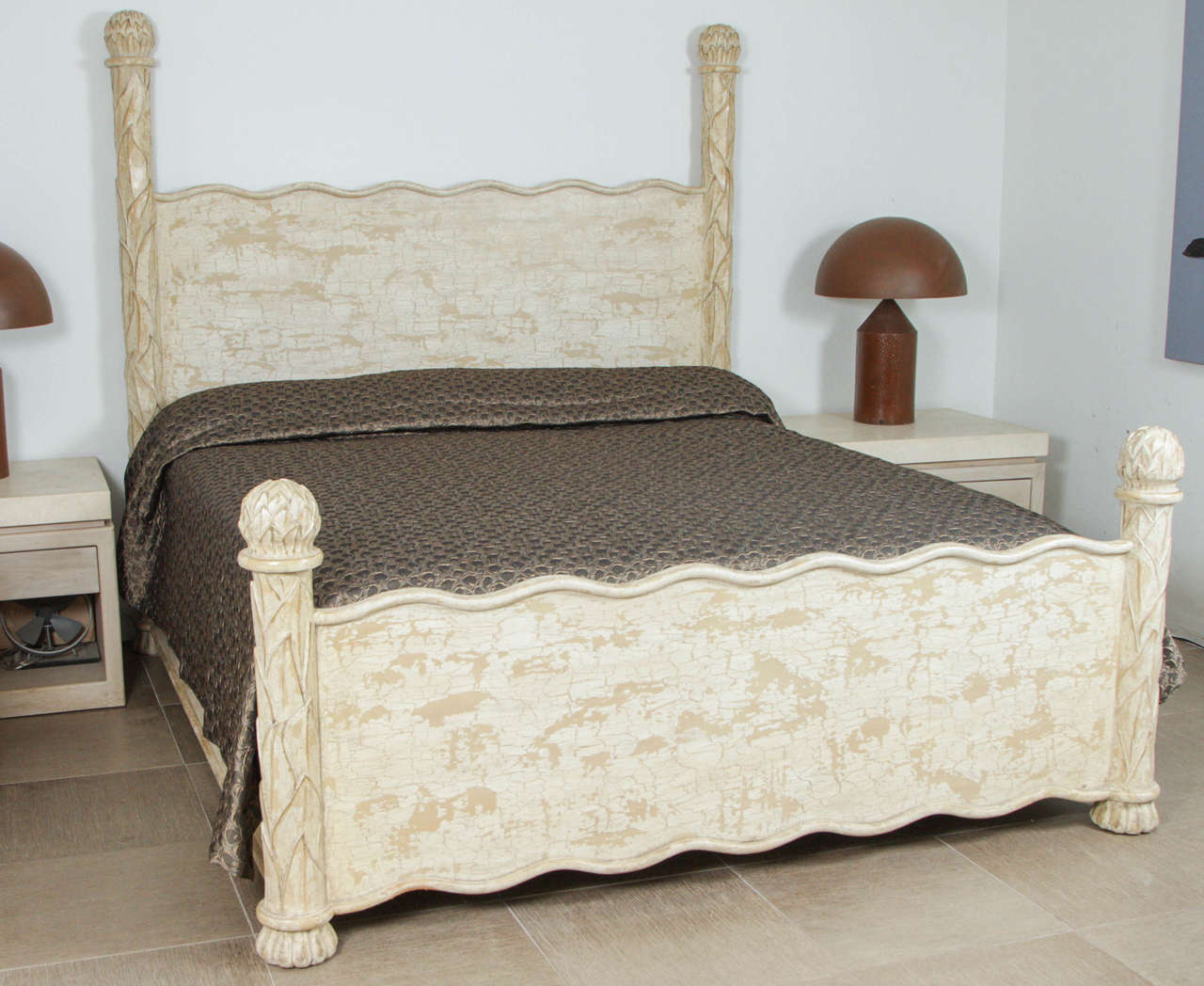 Carved wooden bed frame.
The corner posts are elaborately carved with artichoke finials.
Both headboard and footboard have an undulating molding at the tool and the footboard also has the same motif at the bottom.
The bed has a beige crackled