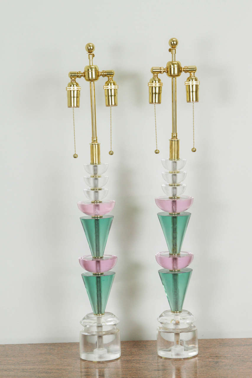 Elegant pair of Lucite lamps by Van Teal.
The lamps have a Memphis feel to them and are made up of clear, green and pink Lucite pieces. They have been newly rewired with brass double clusters.