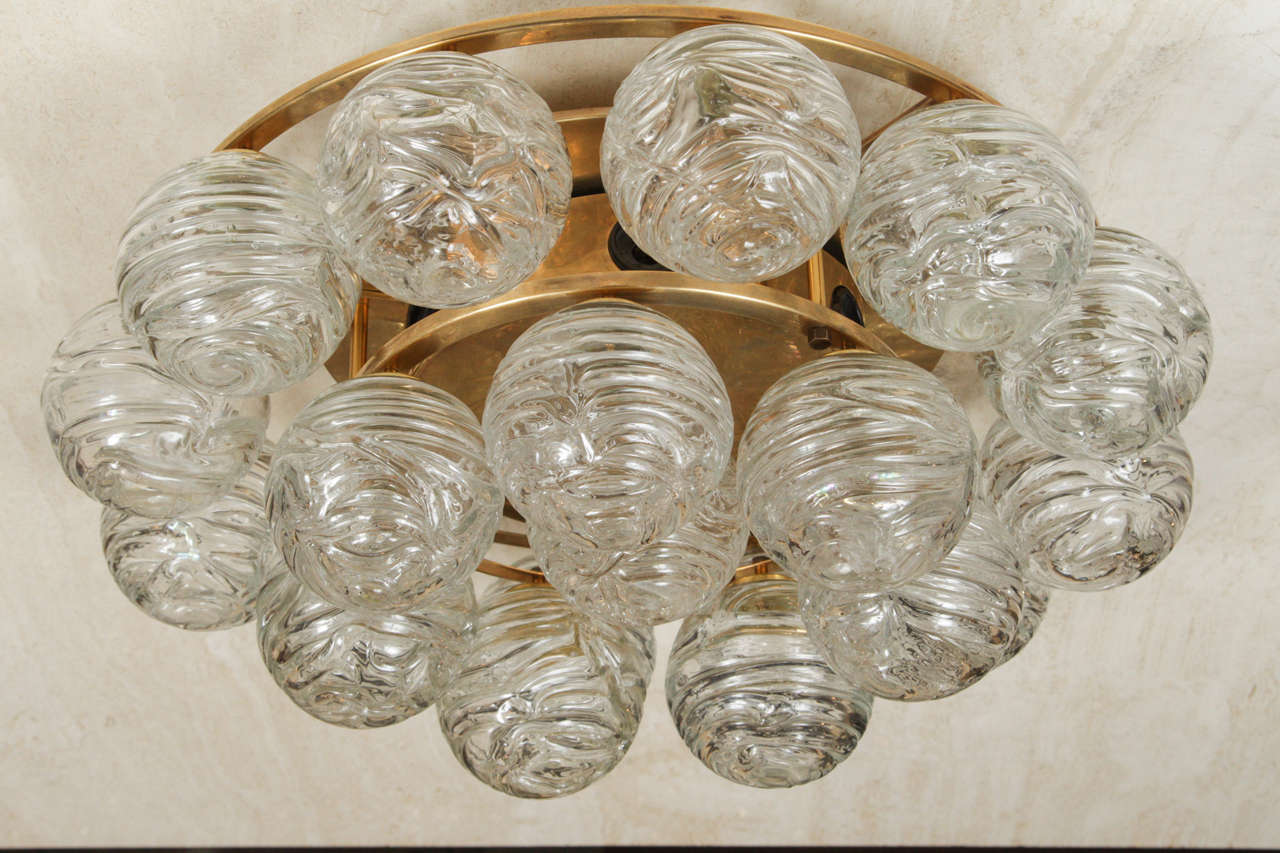 1950s German golden brass fixture, that has six-light sources and 20 handblown swirled glass ball elements. The fixture is simply stunning when illuminated and can be either used as a flush mount or sconce.