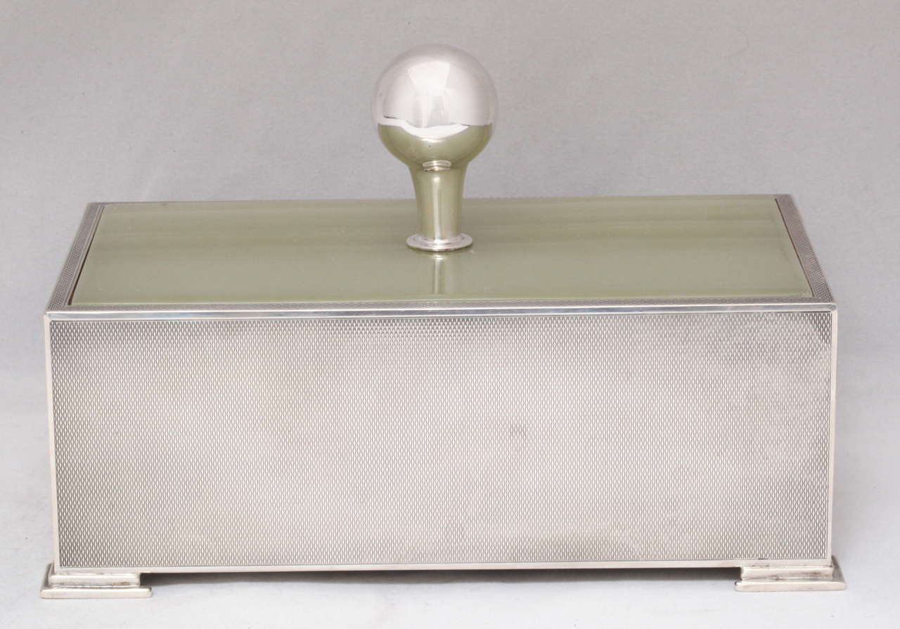 Rare, sterling silver and green onyx, Art Deco footed table box, Birmingham, England, 1952, McClifford Davis - maker. Lid is mounted by a sterling silver finial. Box is engine turned in design, footed and wood lined. Measures: 7