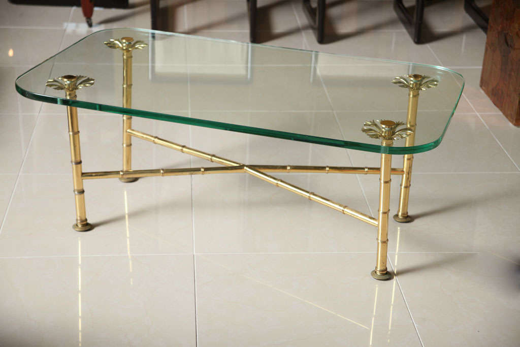 The thick rectangular glass with rounded edges over a reeded base joined with a cross stretcher.