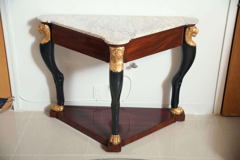 The marble top over a mahogany frieze, the legs in the form of animal legs with lion paw feet and heads, over a mahogany plinth- stamped JACOB, Rue Meslee on the base under marble, possibly adapted.