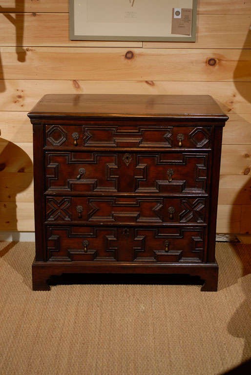 Shown in Oak. Four graduated drawers with original drop handles.