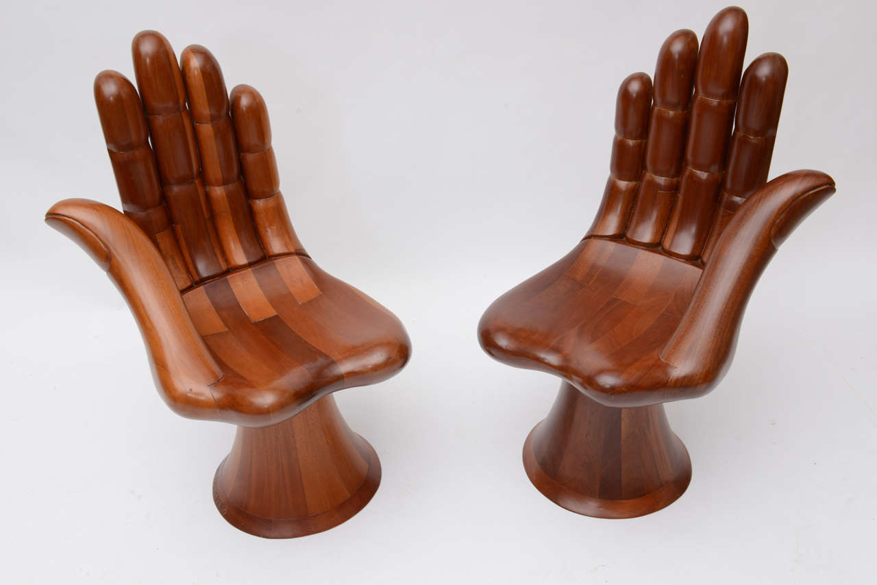 A pair of Pedro Friedeberg hand chairs consisting of a left hand and a right hand version.
Crafted of mexican mahogany and signed with a branded signature.
a pair of these is unusual and desirable.